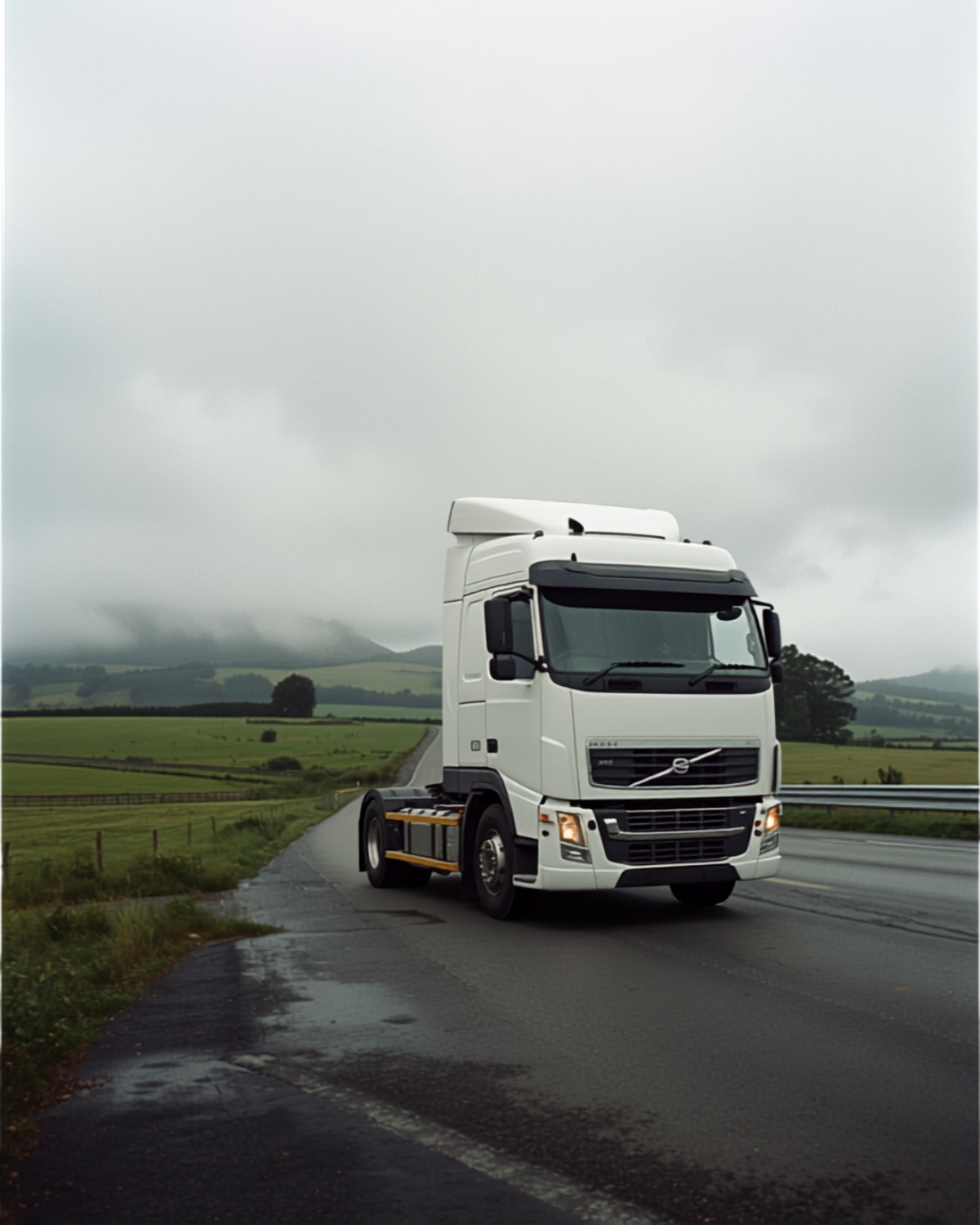 A white truck on a rural New Zealand highway under low cloud